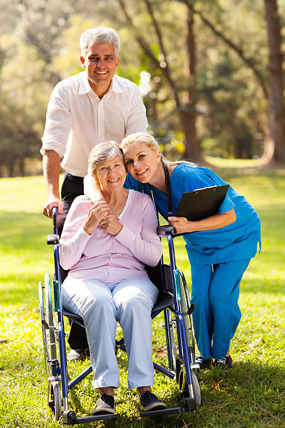 istock caring nurse hugging senior patient 469770651