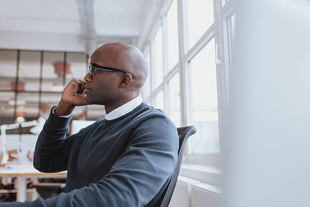 istock Young man at work answering a phone call 469772380