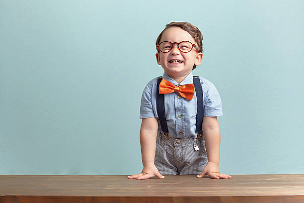istock Happy little boy in an orange bow tie and glasses 469772412