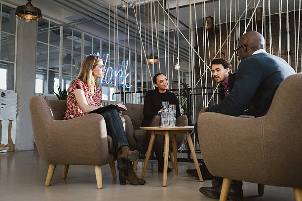 istock Diverse group of young people having a meeting in lobby 469772478
