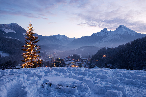 Christmas tree at Lockstein at sunset in front of mount Watzmann, Berchtesgaden, Germany.