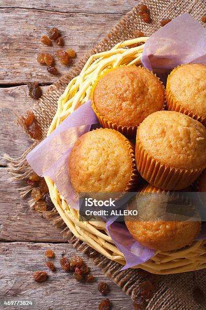 Orange Muffins In A Basket And Raisins Top View Vertical Stock Photo - Download Image Now