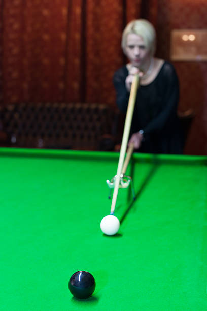 blonde girl playing snooker