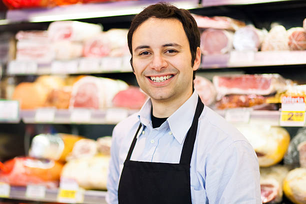 istock Smiling shopkeeper in a butchery 469776588