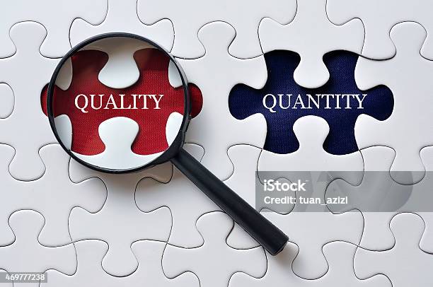 Magnifying Glass On Missing Puzzle With Qualityquantity Word Antonym Concept Stock Photo - Download Image Now