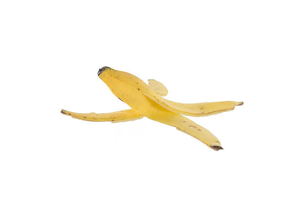 istock slippery banana skin on a white background 469777622