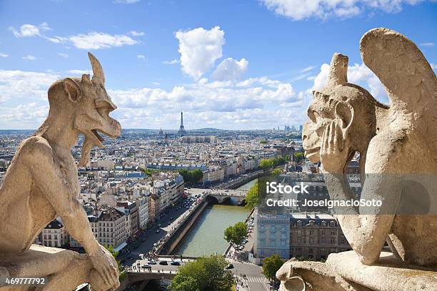 Paris Skyline Framed By Two Gargoyles Of Notre Dame Stock Photo - Download Image Now