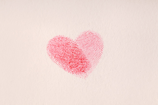 Heart-shaped fingerprint isolated on the paper.