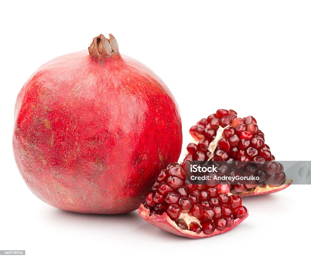 pomegranate with pieces and grains isolated whole pomegranate with pieces and grains isolated on white background 2015 Stock Photo