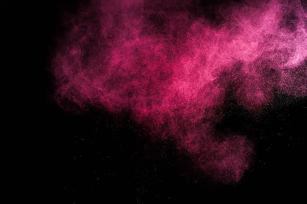 Abstract red and pink paint Holi. Abstract red and pink powder explosion on black background.