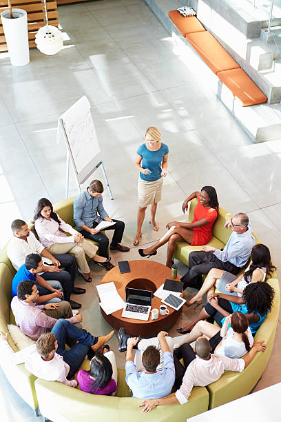 Businesswoman making presentation to colleagues