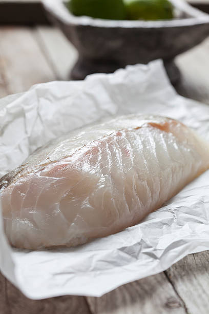 istock Raw fish fillet, cod on greaseproof paper 469781820