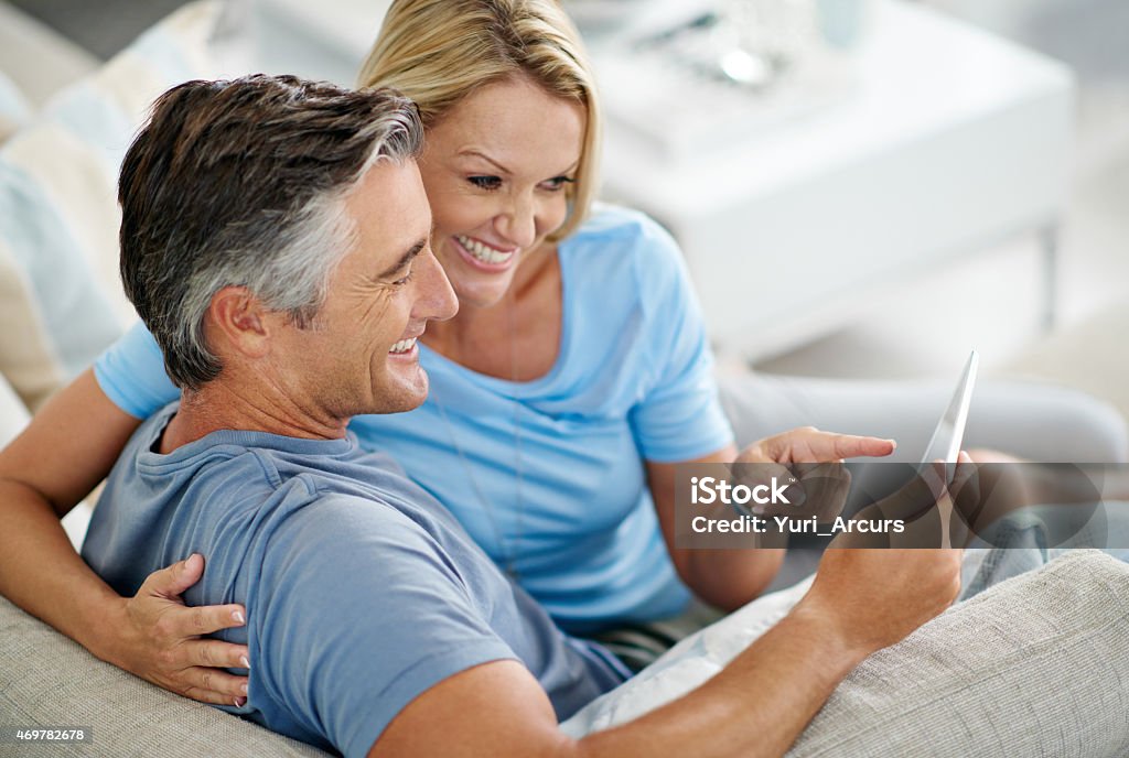 This looks promising! Shot of a smiling couple sitting at home using a digital tablethttp://195.154.178.81/DATA/i_collage/pi/shoots/790866.jpg Digital Tablet Stock Photo