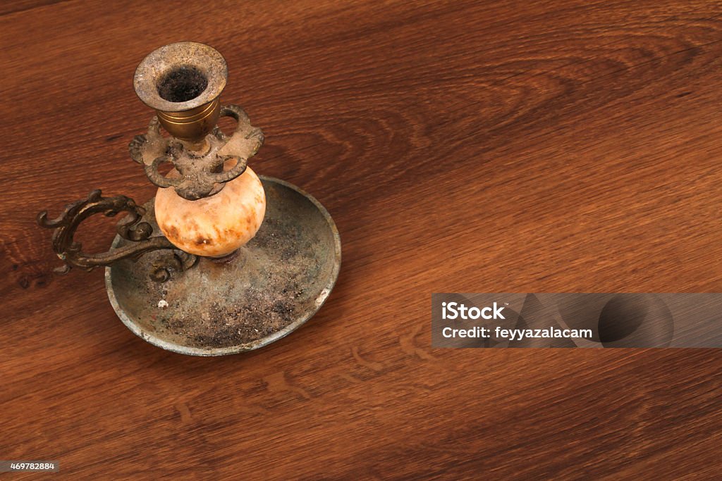 The Vintage candlestick on the wood This is a vintage candlestick. And this object used on the wood. 2015 Stock Photo