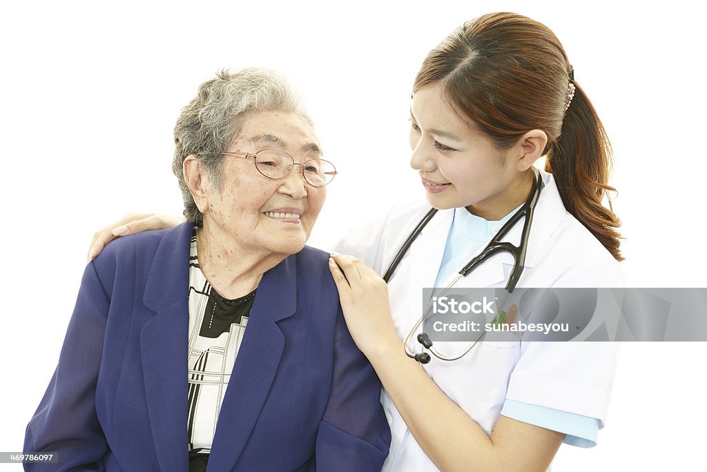 Smiling Asian medical doctor and senior woman Smiling Asian medical doctor and senior woman isolated on white background Adult Stock Photo