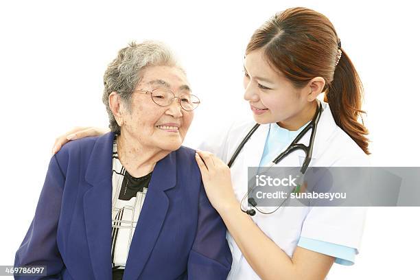 Smiling Asian Medical Doctor And Senior Woman Stock Photo - Download Image Now - Adult, Affectionate, Aging Process