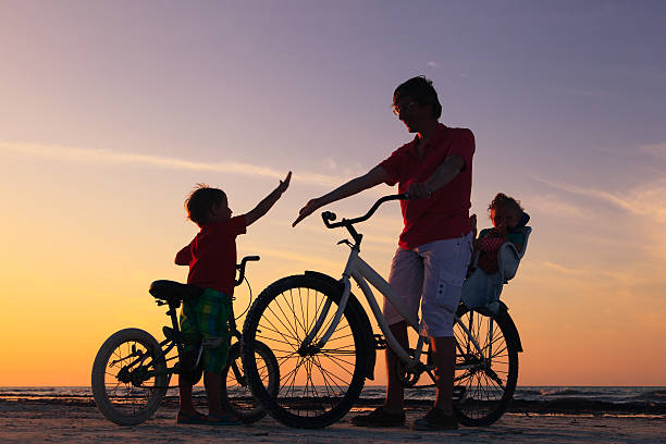 istock father with two kids on bikes at sunset 469787134