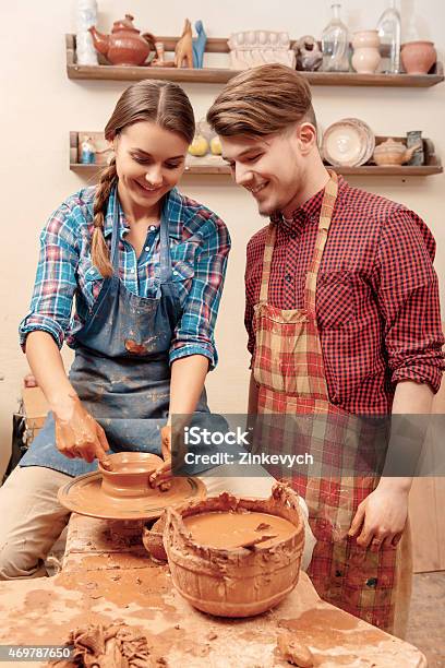 Couple Works On The Pottery Wheel Stock Photo - Download Image Now - 2015, Art, Art And Craft
