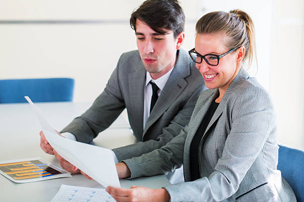 istock Young copuple of business people working with graphs 469787740