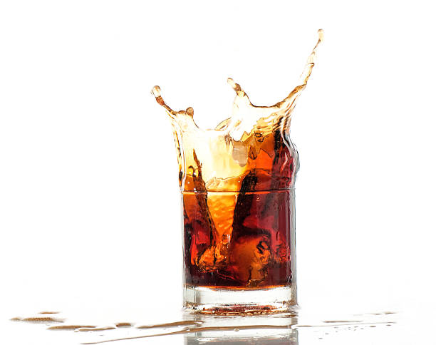 istock splash of cola in glass isolated on white background 469788980