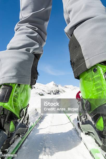 Close Up Of Skiers Boots And Skis From Ground Level Stock Photo - Download Image Now