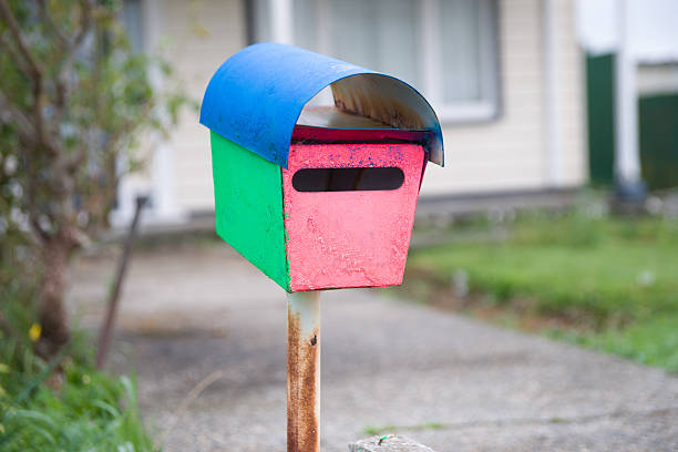 istock Old brightly painted letterbox at end of path 469789726