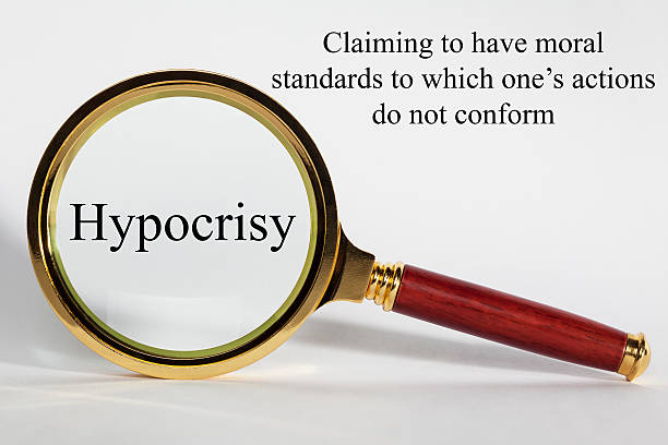 Hypocrisy Concept Hypocrisy Concept - looking at hypocrisy through a magnifying glass, and definition. hypocrisy stock pictures, royalty-free photos & images