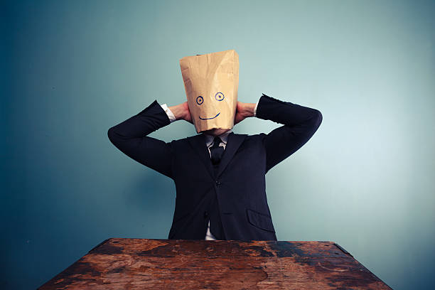 istock Businessman with bag over head relaxing 469793217