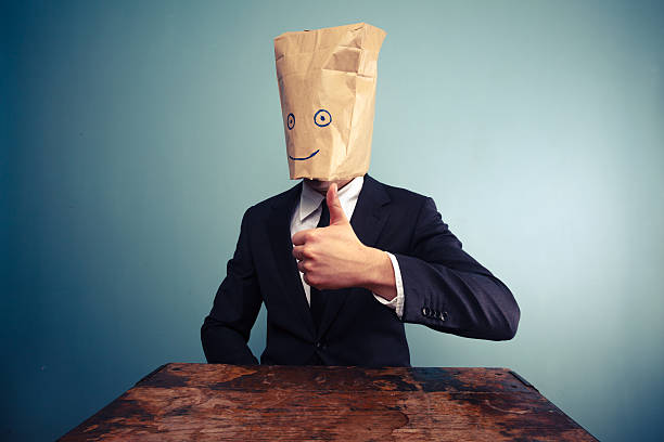 istock Businessman with bag over head giving thumbs up 469793603