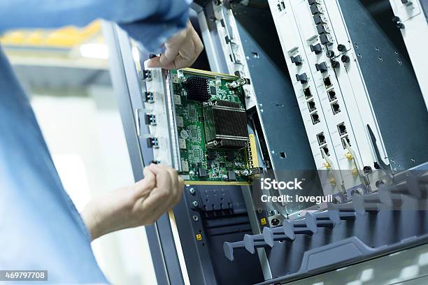 Telecommunication Engineer Install Hardware To The Data Server Stock Photo - Download Image Now