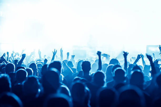 istock Blues hued concert crowd with arms raised 469797756