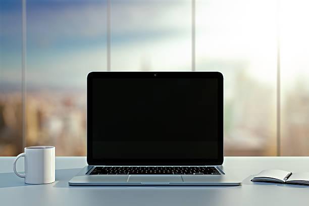 istock laptop, cup and diary on table in office 469798462