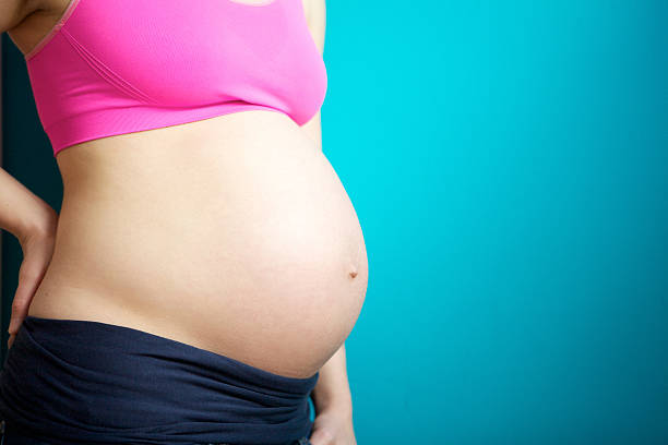 istock Close up pregnant female stomach 469799617