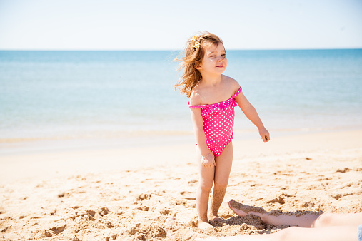 Portrait of a beautiful little girl happy about spending the day at the beach