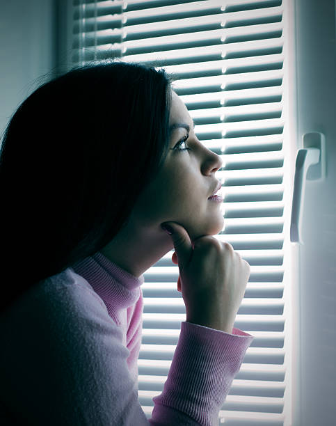 istock Thoughtful girl in the window 469801539