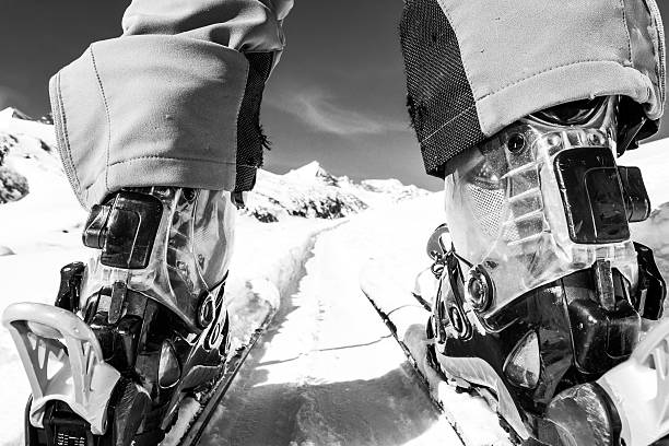 Close up of skier's boots and skis from ground level. stock photo