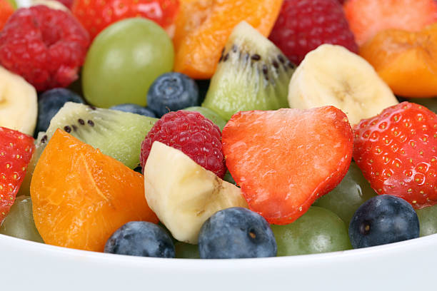 istock Closeup fruit salad in a bowl with strawberries, blueberries, apricots 469802900