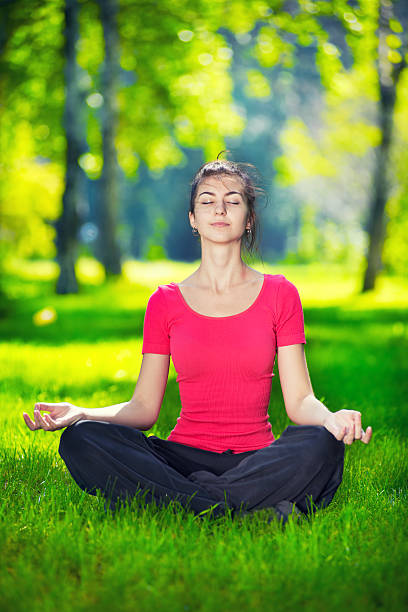 istock Young woman doing yoga exercises 469802920