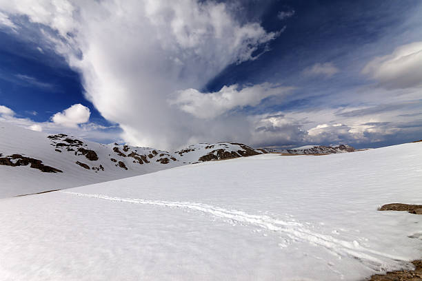 istock Snowy mountains and sky with clouds 469802932