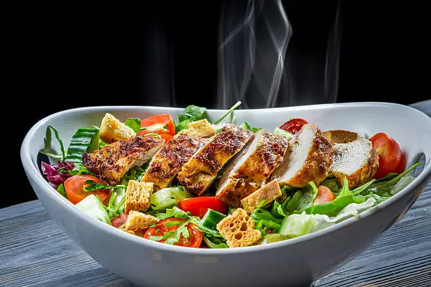 Photo of Meal consisting of grilled chicken pieces and salad