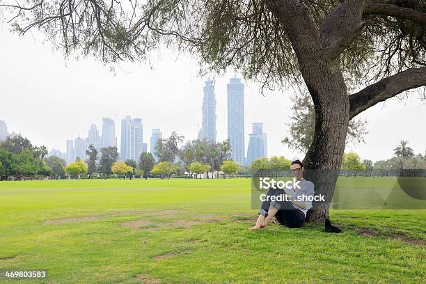 Young Woman Reading A Book In The Park Stock Photo - Download Image Now - Adult, Book, Brown Hair