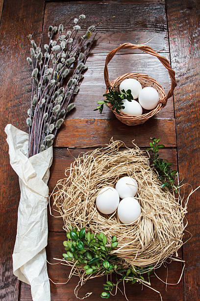 istock Easter composition of catkins and eggs on wooden table 469805766