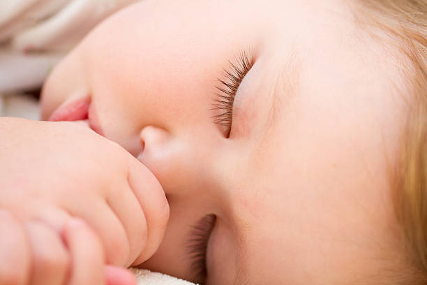 istock Adorable little girl sleeping in a bed 469806888