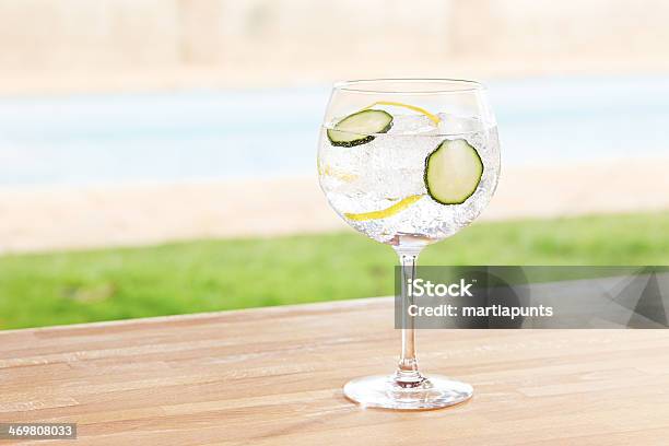 Cucumber Gin And Tonic Cocktail By A Pool Outdoors Stock Photo - Download Image Now - Gin, Gin Tonic, Cucumber