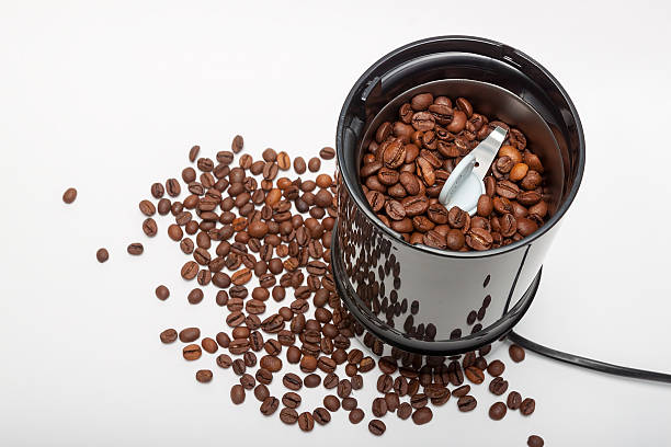 istock Electric coffee-mill machine with roasted coffee beans on isolate background 469808871