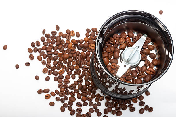 istock Electric coffee-mill machine with roasted coffee beans on isolate background 469808905