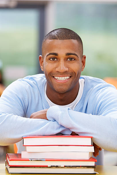 istock Male Student Studying In Classroom With Books 469808929
