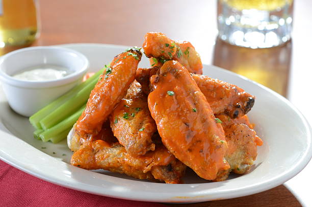 Plate of Buffalo Wings with Celery and Blue Cheese stock photo