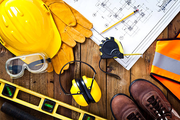 istock Protective workwear and construction blueprint on wood background 469815542