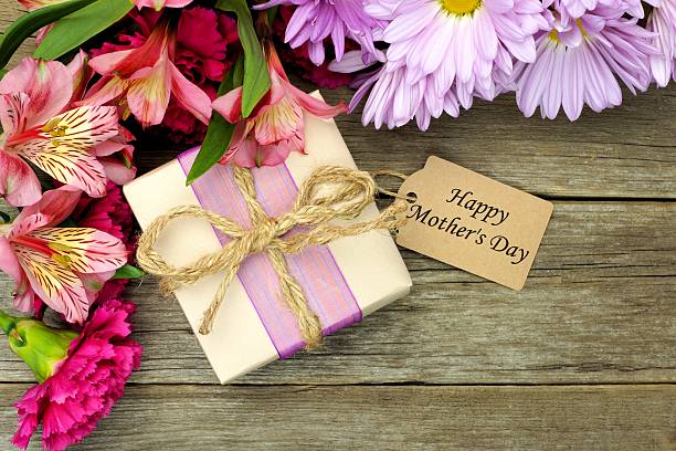 istock Mother's Day gift box and flowers on wood 469816088